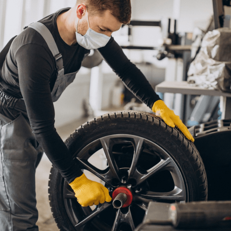 mechanic doing wheel alignment